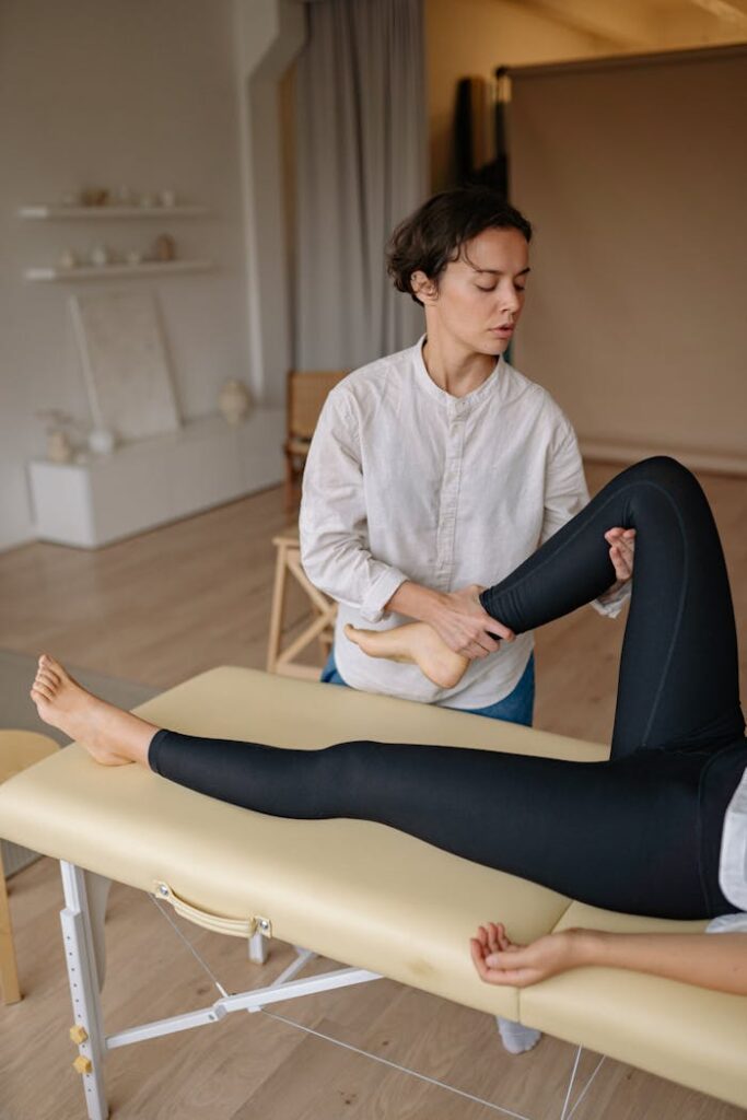Woman receiving a leg massage in a serene spa environment, promoting relaxation and wellness.
